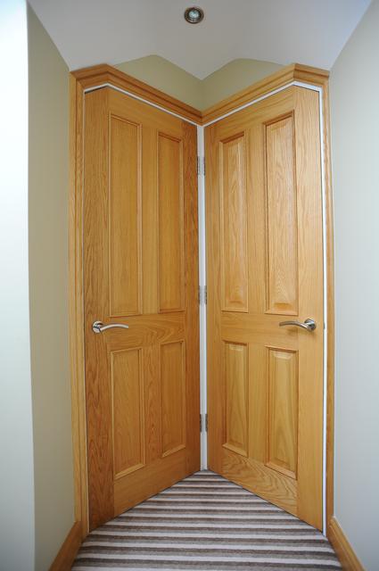 oak doors in loft conversion cleverly  fitted at a angle so they will both fit by apex loft conversions  